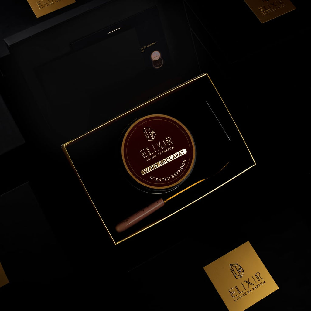 The Ward Baccarat box open, the burgundy tin seated inside beside its spoon